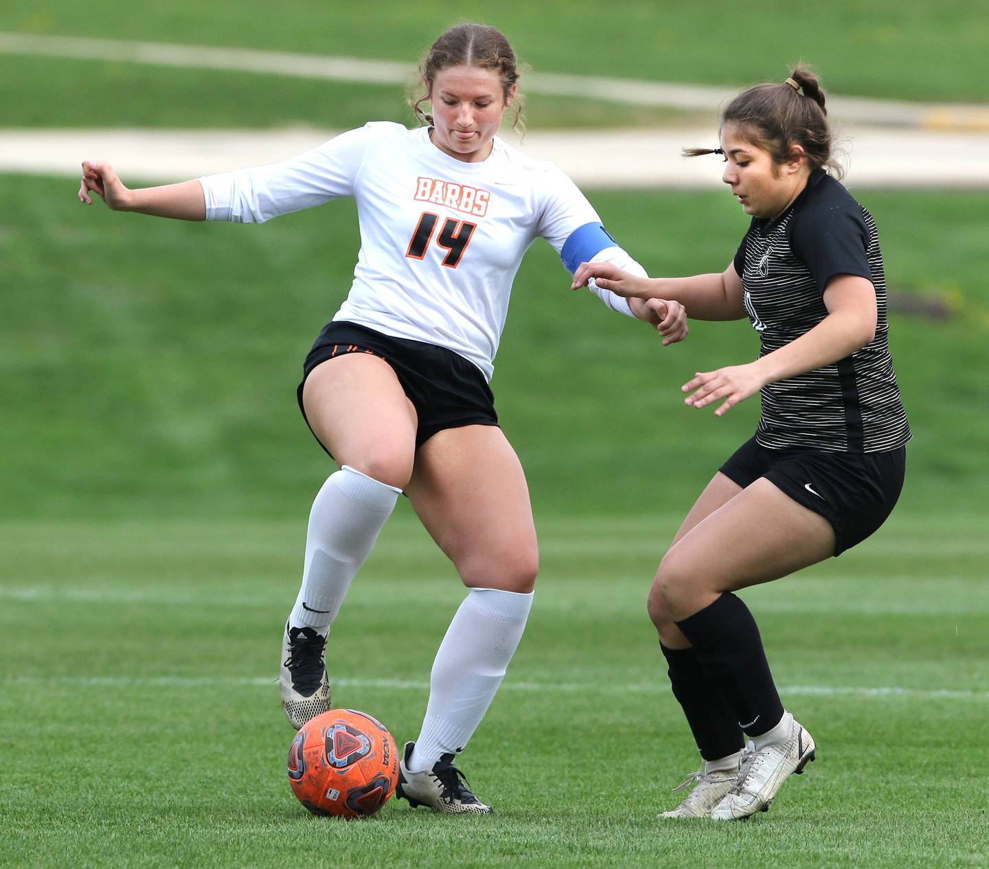 DeKalb's Natalie Rosenow and Sycamore's Mariana Martinez go after the ball during their game Monday, May 2, 2022, at Sycamore High School.