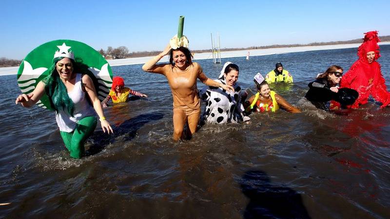 A crew from Lambs Farm exits the water Sunday, Feb. 20, 2022, during the Polar Plunge in Fox Lake. The plunge raised an estimated $52,000 for Special Olympics Illinois.