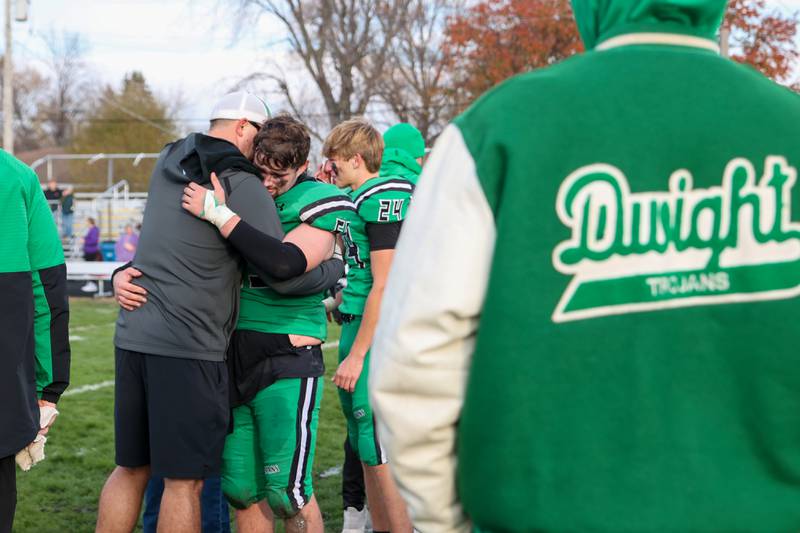 Landon Burkhardt of Dwight/Gardner-South Wilmington hugs coach after loss to Farmington on Saturday, November 16, 2024 at Dwight High School in Dwight.