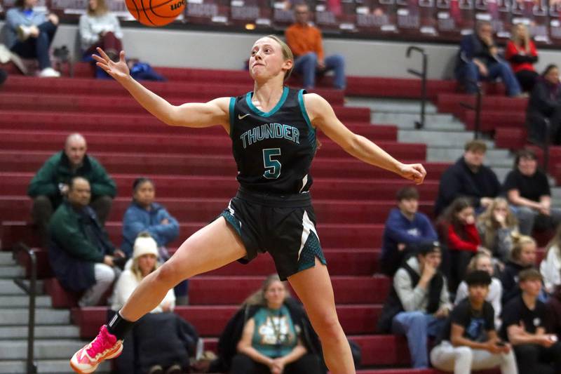 Woodstock North’s Allyson Schaid saves the ball from sailing out of bounds in varsity girls basketball on Tuesday, Dec. 2, 2025, at Marengo High School in Marengo.