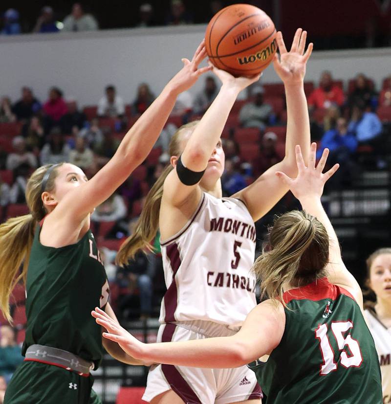 Montini's Victoria Matulevicius  shoots between Lincoln's Kloe Froebe (left) and Piper Whiteman during their game Friday, March 1, 2024, in the IHSA Class 3A state semifinal at the CEFCU Arena at Illinois State University in Normal.