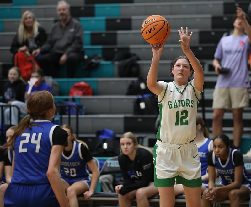Crystal Lake South's Gracey LePage launches a three pointer over Woodstock's Aiyana Fourdyce during the IHSA Class 3A Woodstock North Regional championship girls basketball game on Thursday, Feb. 19, 2026, at Woodstock North High School.