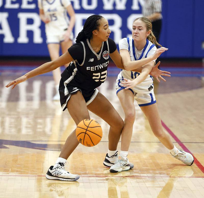 Fenwick's Avani Williams (23) gets a hand on St. Charles North's Keira Connolly (10) during the Dundee-Crown High School 41st Annual Komaromy Classic Friday, Dec. 27, 2024 in Carpentersville.