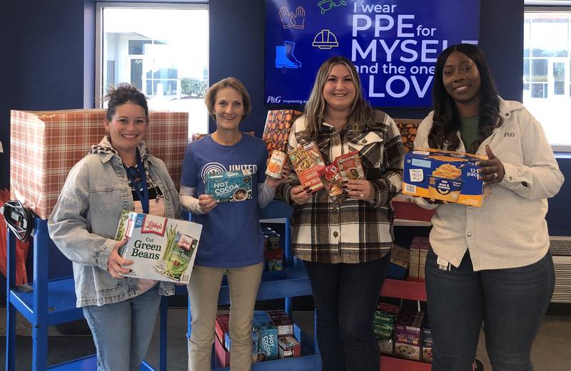 United Way Director Karen Nall and We Care of Grundy County Procter & Gamble employees.