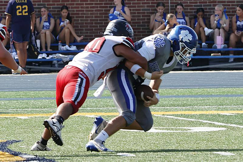 EP's Jordae Crow delivers a quarterback sack to Newman Catholic's Evan Bushman on Saturday in Sterling;