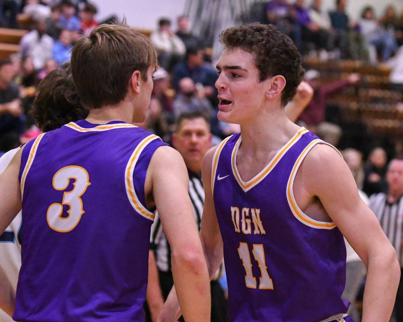 Downers Grove North's Jack Crowley (11) celebrates with teammate Nolan Hurter (3) after Nolan gets fouled while making a basket during the game on Saturday Dec. 21, 2024, while traveling to take on crosstown rival Downers Grove South High School.