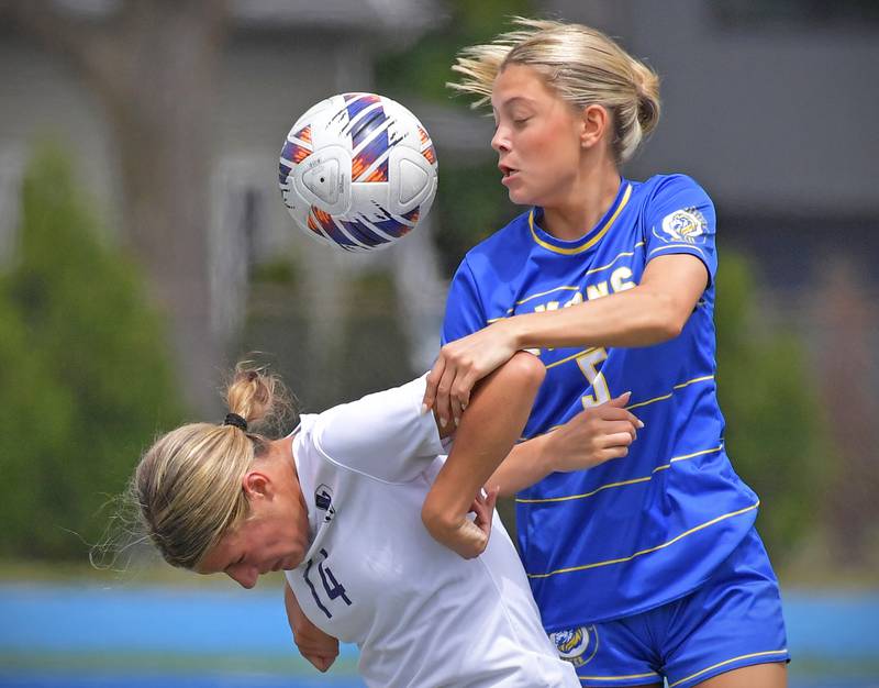 A header attempt bounces off of Downers Grove North’s Gabriella Menzione’s back as Lyons Township’s Quinn Conway defends during their Class 3A Lyons Regional final on May 23, 2026 at Lyons Township High School in LaGrange.