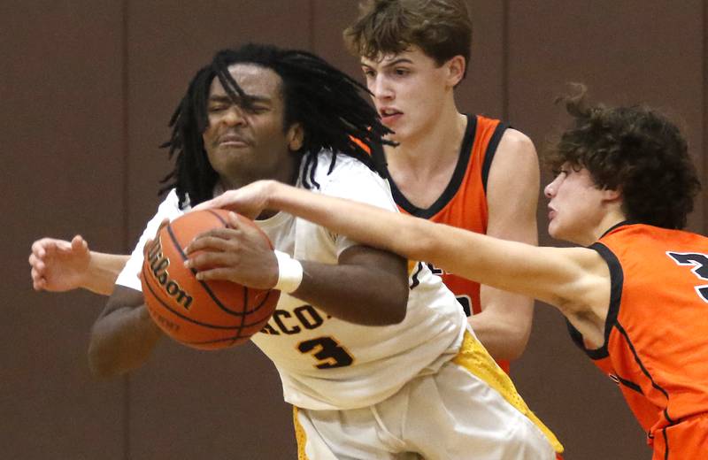 McHenry's Marko Stojich (right) tries to steal the ball from Jacobs' Emaan Thomas as McHenry's Caleb Jett applies defensive pressure in the final minute of a Fox Valley Conference boys basketball game on Wednesday, Nov. 29, 2023, at Jacobs High School in Algonquin.