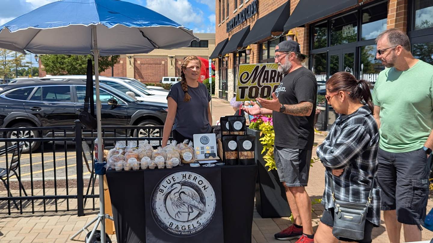 Kim Whisenhunt, owner of Blue Heron Bagels in Shorewood, participated in the "Meet the Makers" event at Will County Brewing Company in Shorewood on Sunday, Aug. 24, 2025. Jamie Albert, owner of Will County Brewing Company, talks to Whisenhunt as attendees check out Whisenhunt's bagels.