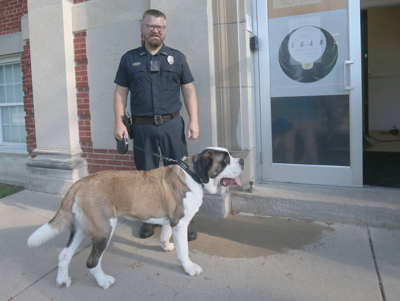 School Resource and Peru Police Officer Brian Zebron, poses with his Peru Police Department therapy K-9 dog at SOAR (Students Obtaining Achievement and Responsibility) on Thursday, Aug. 21, 2025 in Peru. Haven assists the community with emotional support. The school, provides support to students in kindergarten thru 12th grade with significant behavioral and emotional needs.