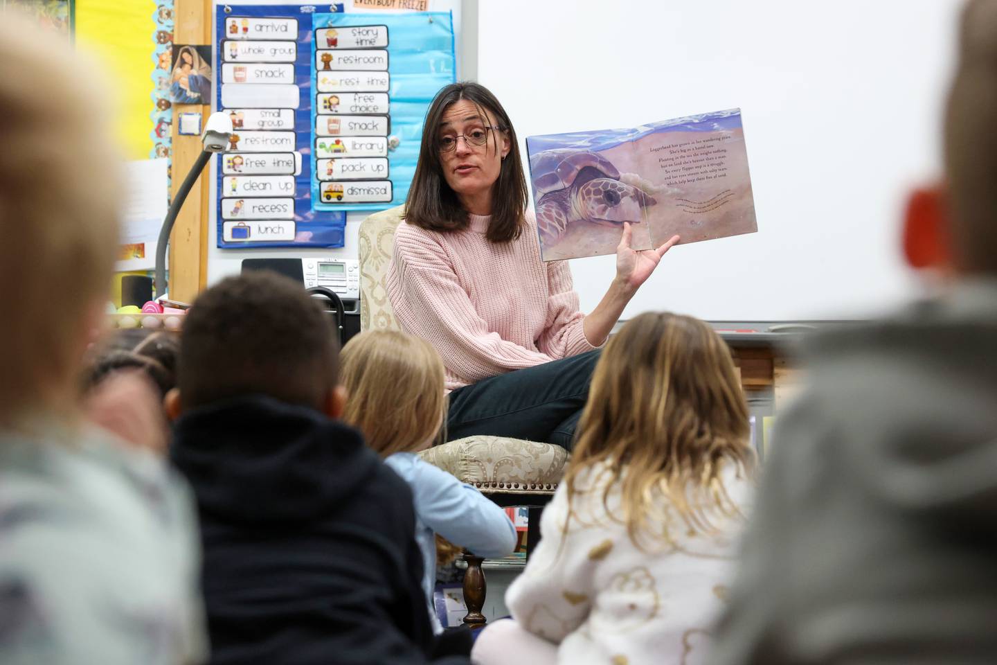 Becky Williams reads a story to her preschool class at Bishop McNamara Catholic School.