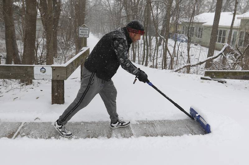 Brandon Yankowski shovels the sidewalk on Wednesday, Feb. 12, 2025, along Broadway Street in Richmond. A winter storm is bring heavy snow to the McHenry County area.