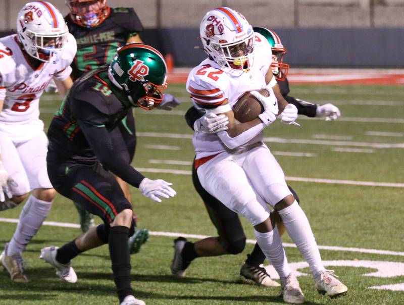 Ottawa's Tristan Finley runs the ball as L-P's Wil Mertes looks to bring him down on Friday, Oct. 6, 2023 at Howard Fellows Stadium.