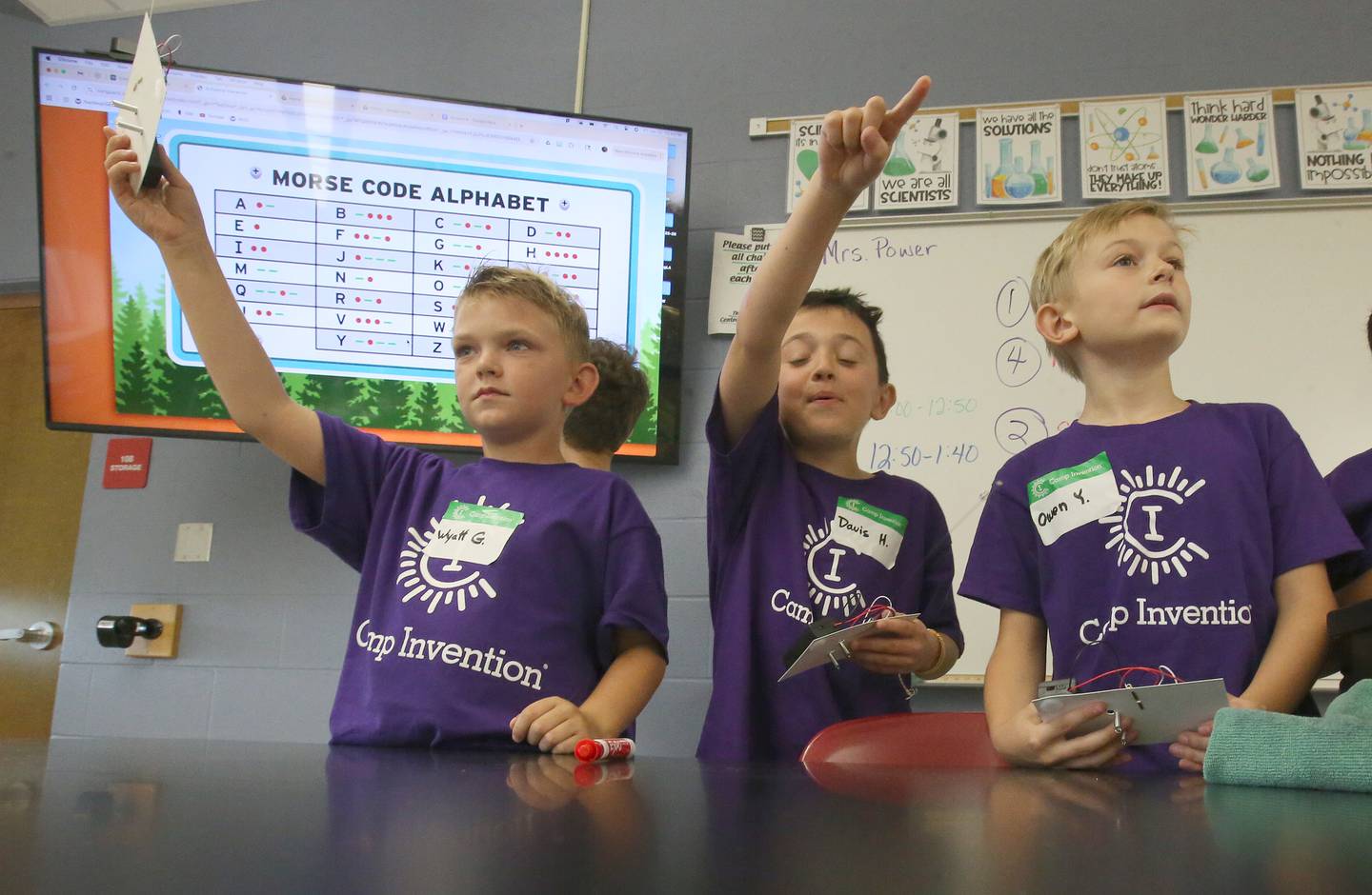 Students Wyatt, Davis, and Owen learn Morse Ccde while making transmitters during Inventor Camp on Friday, June 13, 2025, at Central Intermediate School in Ottawa.