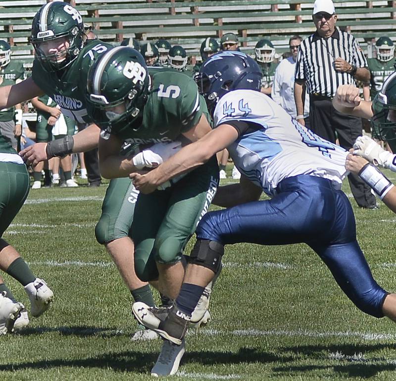 St Bede’s Callan Hueneburg (5) tries to power past Bureau Valley’s Cameron Lemons during the first quarter Saturday, Oct. 1, 2022 at St Bede.