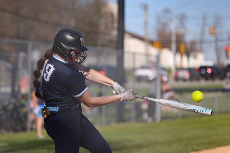 Downers Grove South's Ella Cushing (19) swings away during varsity softball game between St Charles East at Downers Grove South.  April 12, 2023.