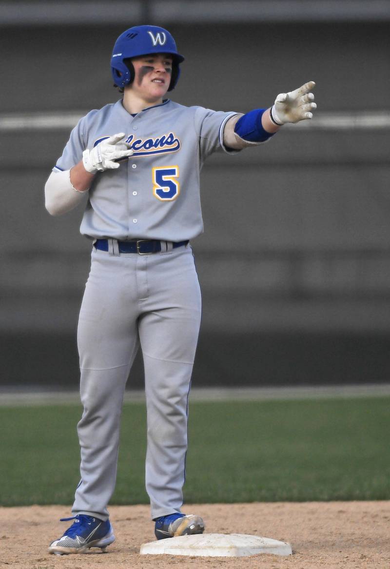 John Starks/jstarks@dailyherald.com
Wheaton North’s Aaron Holland gestures toward his teammates after hitting an RBI double to go ahead of Batavia in a baseball game in Batavia on Monday, April 11, 2022.