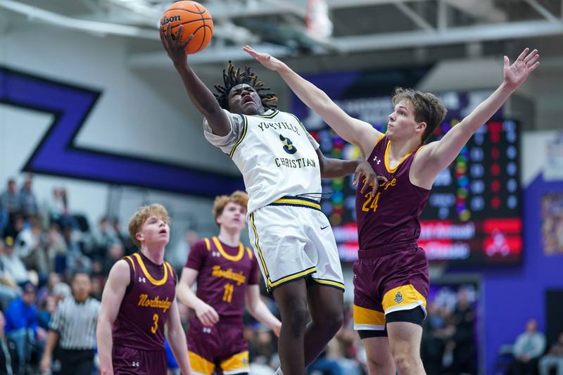 Yorkville Christian's Jayden Riley (3) drives to the hoop against Northridge Prep's Mark Scherer (24) during a semi-final basketball game in the 61st annual Plano Christmas Classic at Plano High School on Friday, December 27, 2024.