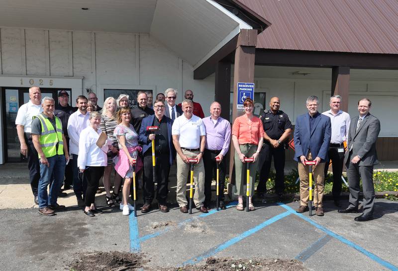 DeKalb city officials pose with sledgehammers after a special meeting of the DeKalb City Council Monday, May 9, 2022, in the parking lot of the former Hillcrest Shopping Center. The meeting was held to kick off the demolition process of the strip mall on Hillcrest Drive which will begin Tuesday morning.