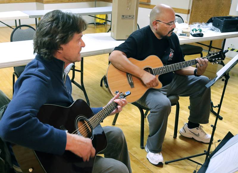 Veterans Ron Lofton (left) and Manuel Olalde play guitar Tuesday, Nov. 26, 2024 during the Kishwaukee Special Recreation Association’s Chords and Camaraderie at the Hopkins Park Community Center in DeKalb.