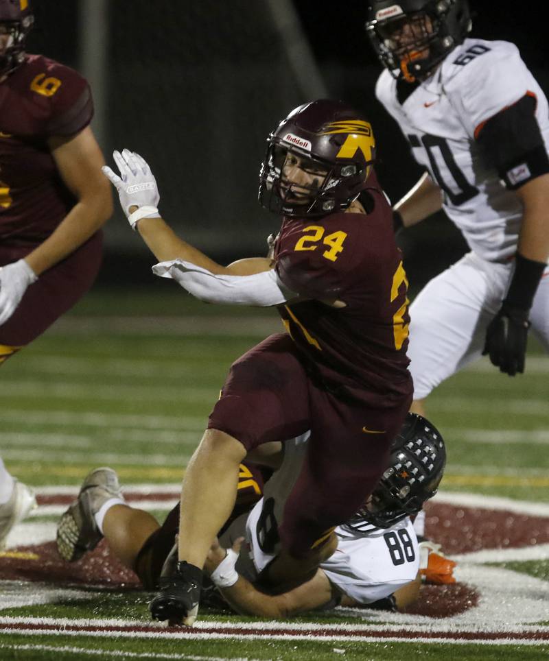 Richmond-Burton's Hunter Carley breaks a tackle attempt of Sandwich's Jeffrey Ashley for a long run during a Kishwaukee River Conference football game on Friday, Oct. 4, 2024, at Richmond-Burton High School.