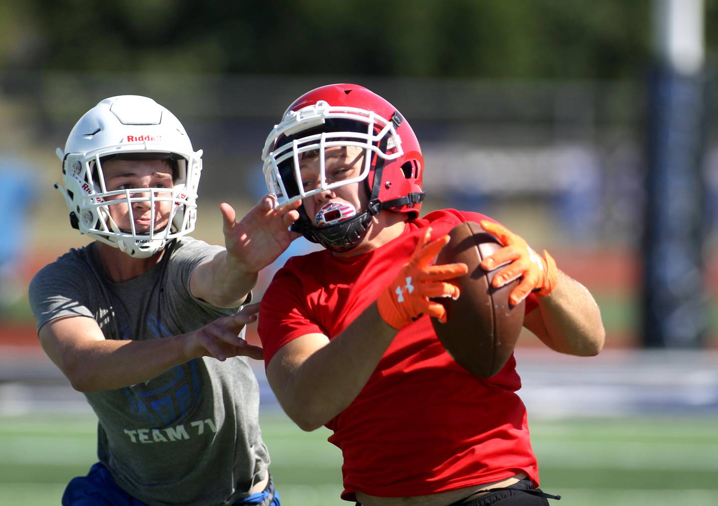 Yorkville’s Colby Henry (right) makes a catch during a 7 on 7 tournament at St. Charles North High School on Thursday, June 30, 2022.