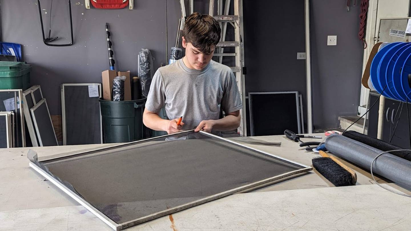 Dante Gentile, 15, of Romeoville, repairs screens in his garage on Friday, April 14, 2023. Dante Gentile started the screen repair business four years ago to help pay for Boy Scout activities. His sister Sophia Gentile, 11, sometimes helps to pay for her Girl Scout activities.