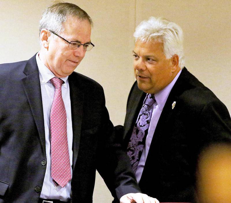 McHenry County Board member Joseph Gottemoller (left) and chairman Jack Franks talk before the start of the Cmmitte of the Whole meeting.