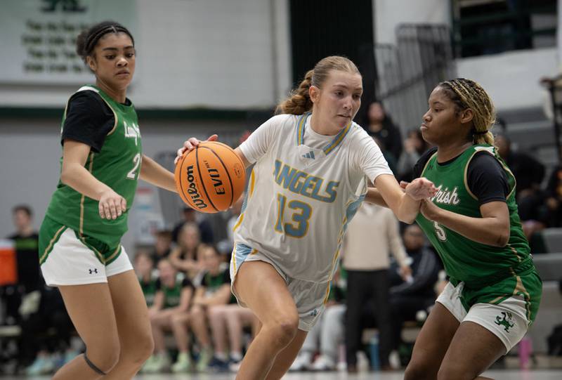 Joliet Catholic's Abby Dulinsky, center, controls the ball as Bishop McNamara's Kaneyce Davis, left, and Eliana Isom, right guard during the Class 2A Regional Championship on Thursday, Feb. 19, 2026.