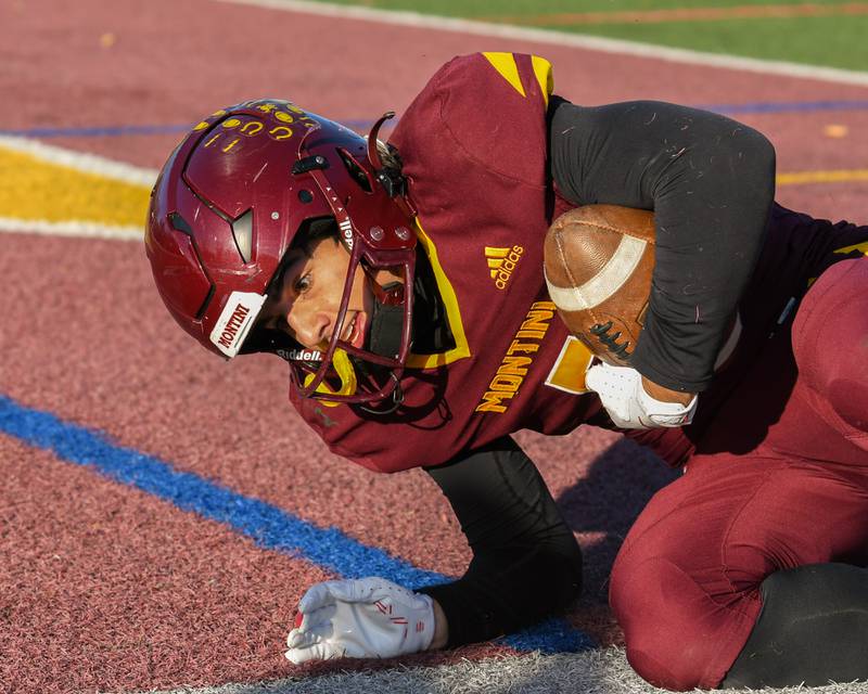 Montini Catholic's Nico Castaldo (5) is all smiles after falling into the endzone with a touchdown pass during the 4A quarterfinals game while taking on Coal City on Saturday Nov. 15, 2025, held at Montini Catholic High School.