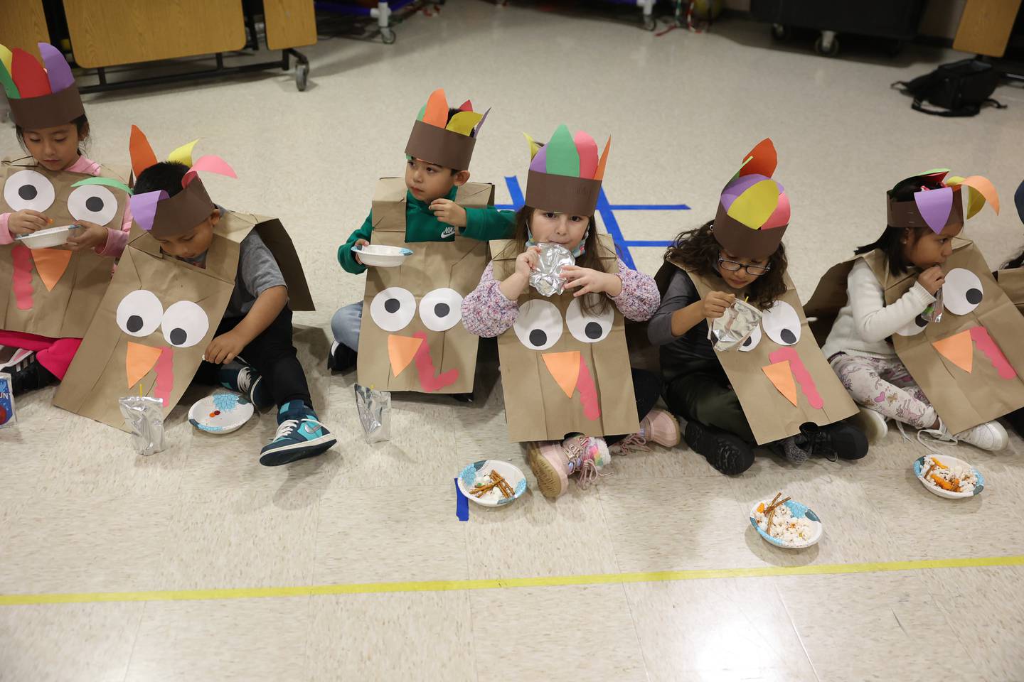 Students enjoy their treats during a Thanksgiving gathering at Thomas Jefferson Elementary School in Joliet on Friday.