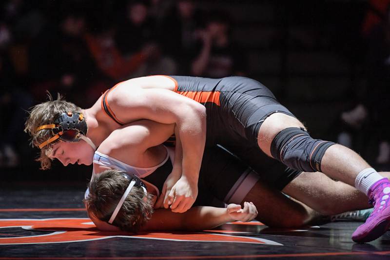 St. Charles East’s Brandon Swartz and Marian Central’s Owen Neuzil wrestle at 215 pounds during a match in St. Charles on Wednesday, December 20, 2023.