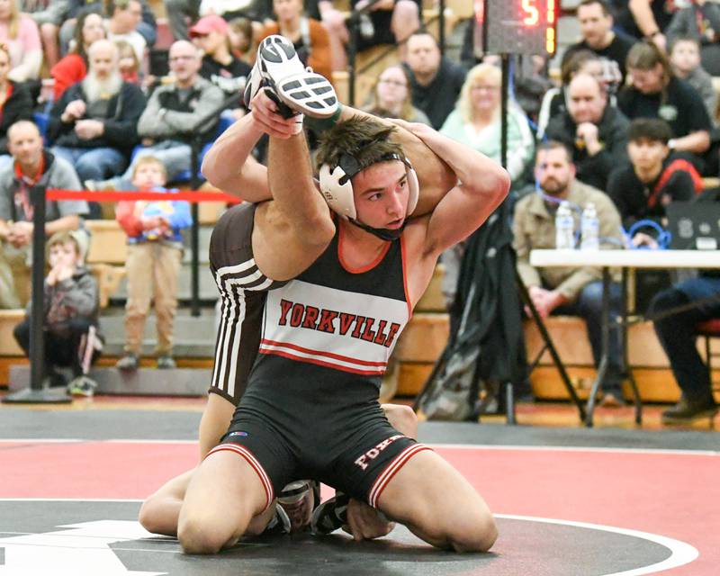 Vincent Konecki  of Yorkville keeps a hold of Aurelio Munoz of Joliet Catholic Academy during the 132-weight class regional meet held on Tuesday Feb. 25, 2025, held at Yorkville High School.