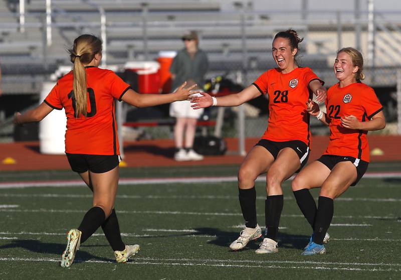 Crystal Lake Central's Brooklynn Carlson (left) is greeted by her teammates, Jillian Mueller, (center) and Olivia Anderson, (right)  after Carlson kicked the game winning shootout gaol during a Class 2A Deerfield Sectional semi-final match against Lake Forest on Tuesday, May 21, 2024, at Deerfield High School.