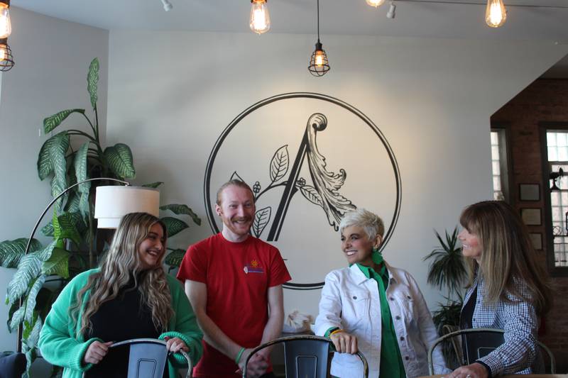 Abby Phillips (from left), Secretary of State’s Organ/Tissue Donor Program regional coordinator Gavin Dillon, Emily Phillips and Aroma Coffee & Wine owner Dawn Kincaid gather together to create a organ donation awareness event in Crystal Lake. Emily Phillips is on the liver transplant list. She began an Instagram account with her daughter, Abby Phillips, to share their experiences.