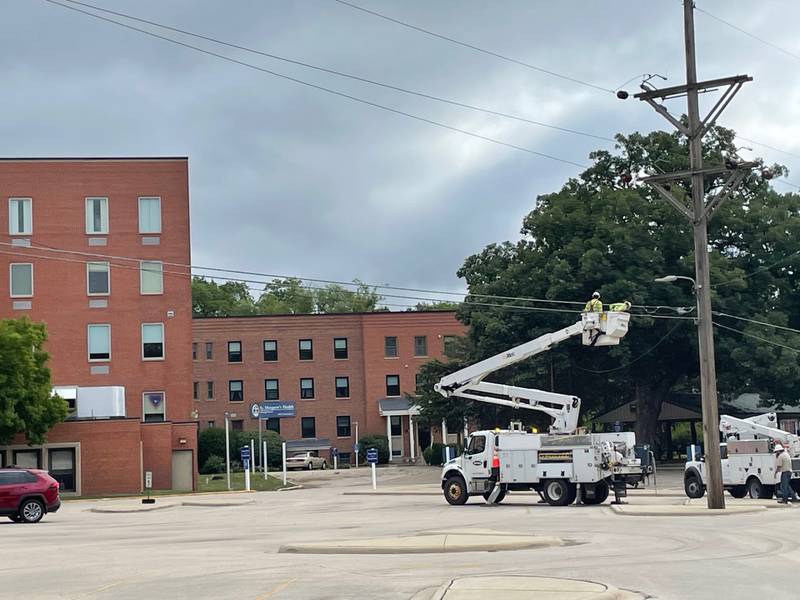 Ameren crews service power lines outside the closed St. Margaret's Health-Spring Valley on Saturday, July 29, 2023, following late night storms that left much of Spring Valley without power.