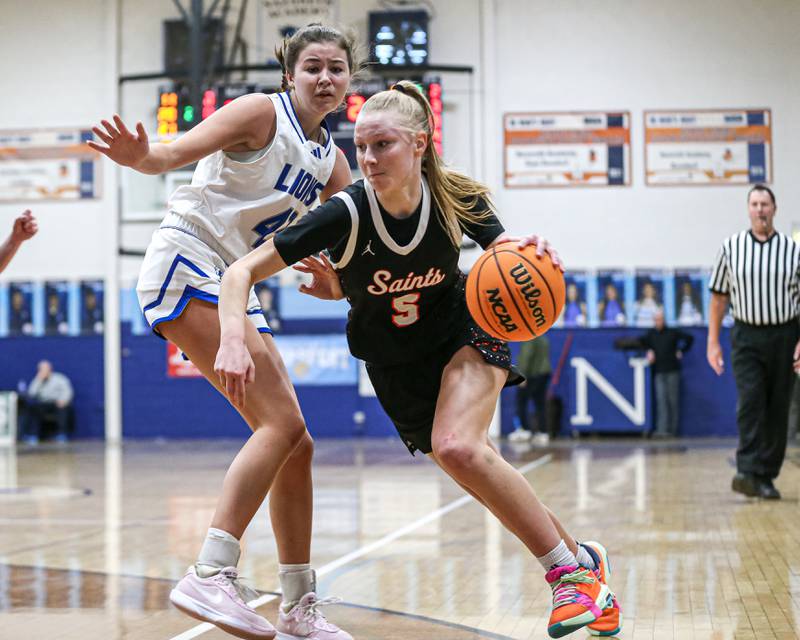 Saint Charles East's Brooklyn Schilb (5) drives past the defense during their Coach Kipp's Hoopfest basketball game between Lyons at St Charles East. Jan 18, 2025 in La Grange.
