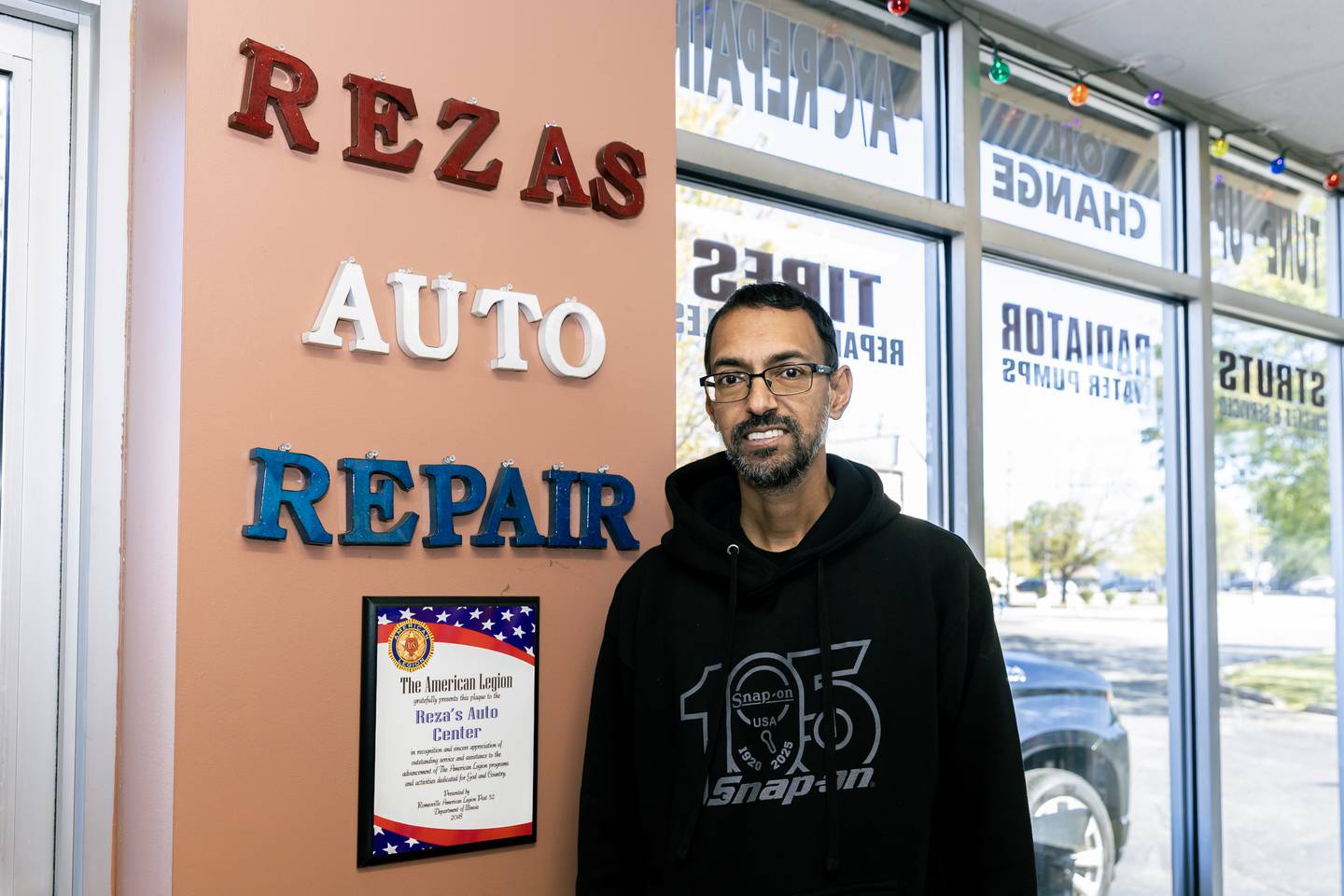 Crest Hill business owner Reza Jaddi, who supports veterans anyway he can, poses for a photo in Reza’s Auto Repair in Crest Hill on Oct. 9, 2025.