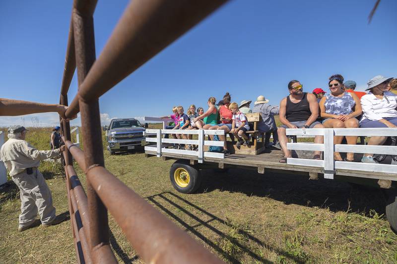Visitors to Nachusa Grasslands climb aboard a wagon for a tour of the bison Saturday, Sept. 21, 2024. The Nature Conservancy held their annual Autumn on the Prairie over the weekend and offered tours to get as up closer and personal as was safe to the native buffalo.