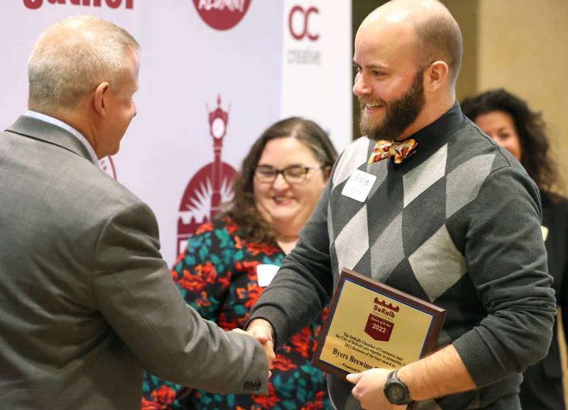 Steve Byers, co-owner of Byers Brewing Company, is congratulated by DeKalb Mayor Cohen Barnes after being announced as the 2022 Business of the Year Thursday, Feb. 9, 2023, during the DeKalb Chamber of Commerce’s Annual Celebration Dinner in the Barsema Alumni and Visitors Center at Northern Illinois University.