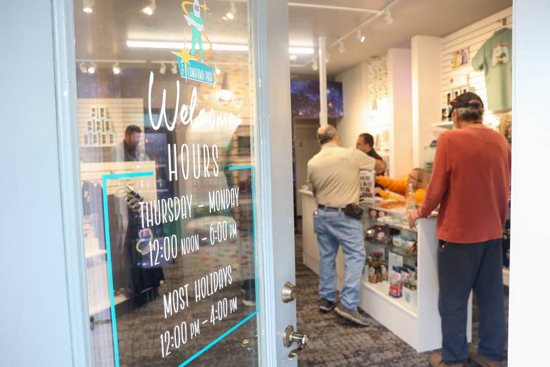 Attendees shop for merchandise during The Landing Pad Souvenir Shop's official ribbon-cutting ceremony at Wilmington's South Island Park on Thursday, May 22, 2025.