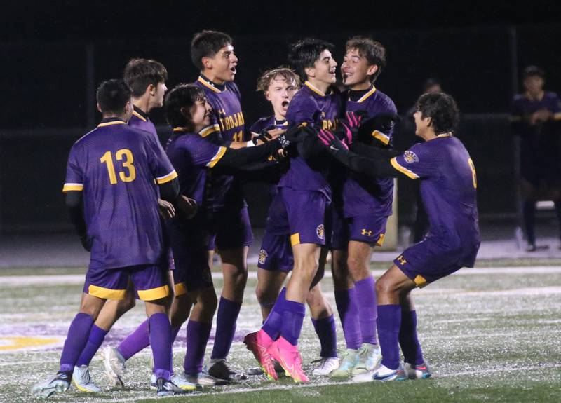 Members of the Mendota boys soccer team surround teammate Johan Cortez after he scores a goal against Kewanee during the Class 1A Regional game on Wednesday Oct. 18, 2023 at Mendota High School.