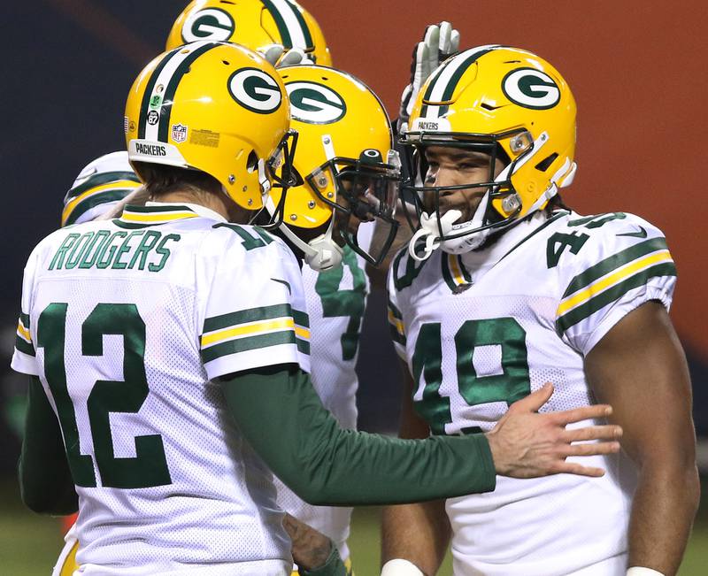 Green Bay Packers quarterback Aaron Rodgers (12) celebrates with Green Bay Packers tight end Dominique Dafney (49) after his touchdown catch during their game against the Bears Sunday at Soldier Field in Chicago.