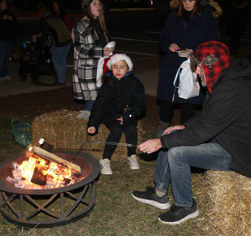 Attendees of A Merry Little Sandwich Christmas make s’mores on Saturday, Dec. 7, 2024.
