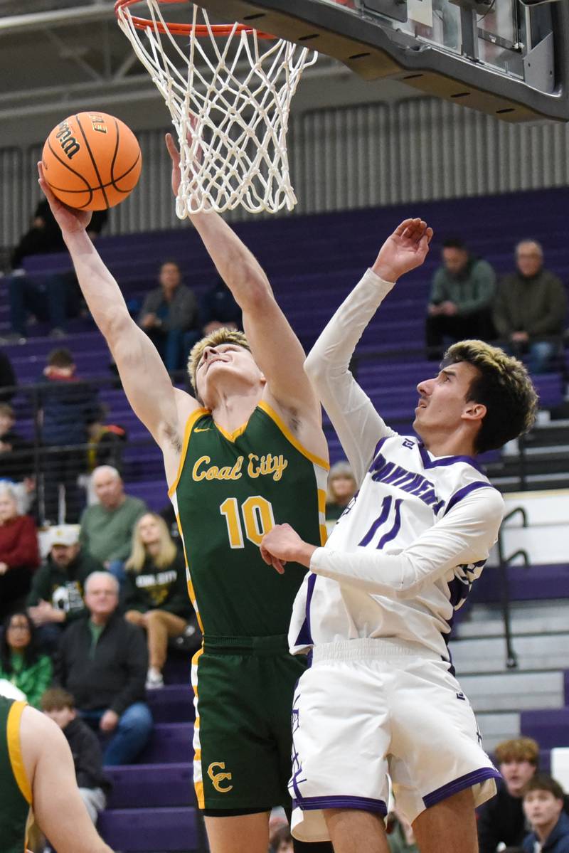 Coal City's Parker Jacovec, left, grabs a rebound over Manteno's Braden Campbell during the IHSA Class 2A Manteno Regional quarterfinals Monday, Feb. 23, 2026.