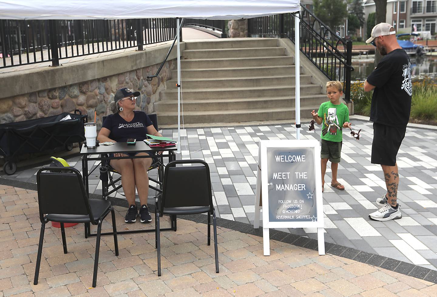 Amy Humbracht, the manager of the McHenry Riverwalk Shoppes, talks with shoppers on Friday, Aug.15, 2025, during McHenry’s 815 Day.