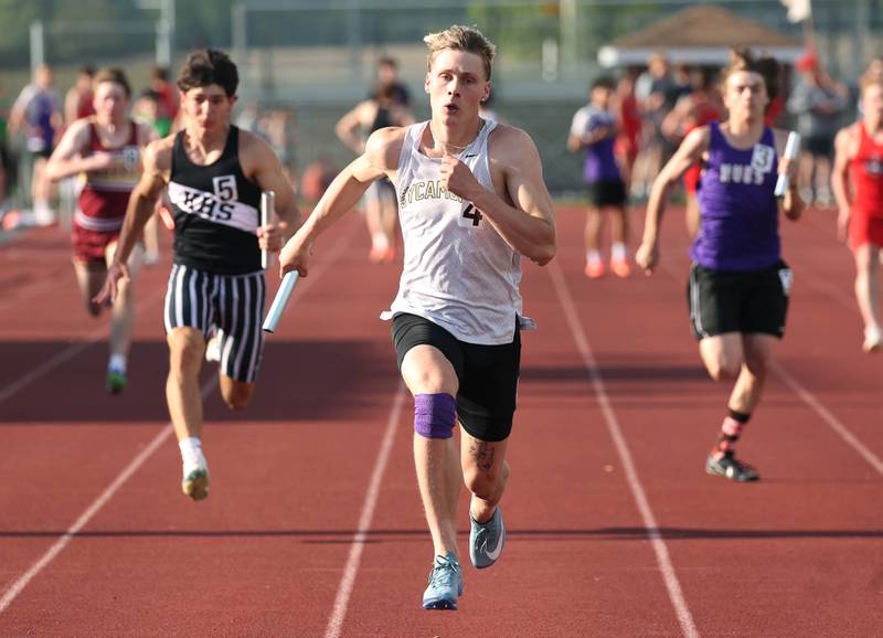 Sycamore’s Aidan Wyzard runs the anchor leg for his team in the 4x100 meter relay and crosses the finish line first Tuesday, May 13, 2025, during the Interstate 8 Conference boys track championships at Rochelle High School.