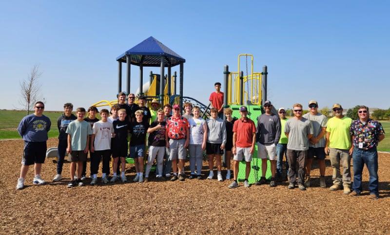 Yorkville Mayor John Purcell joins parks and recreation staff and volunteers from Yorkville Christian High School to celebrate the completion of Prestwick Park Playground in Yorkville in Oct. 2025.