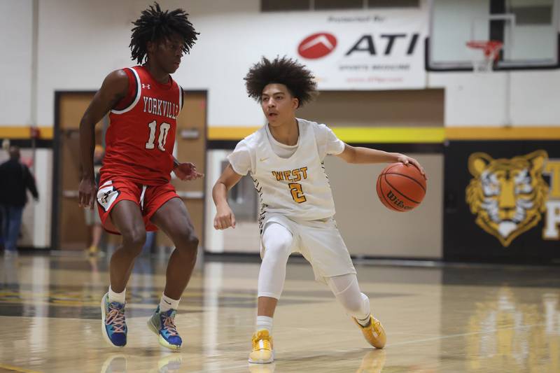 Joliet West’s Corey Nobles works the ball against Yorkville’s Kaevian Johnson on Friday, Jan. 5th, 2024. in Joliet.