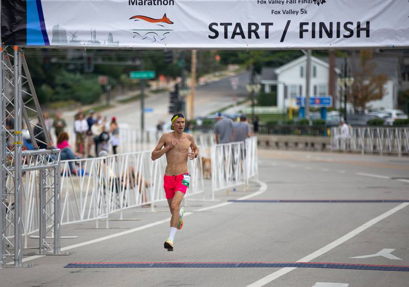 Derek Babson crosses the finish line at the Fox Valley Marathon on Sunday, Sept. 18, 2022. Babson was the first male finisher in the half marathon portion of the race.